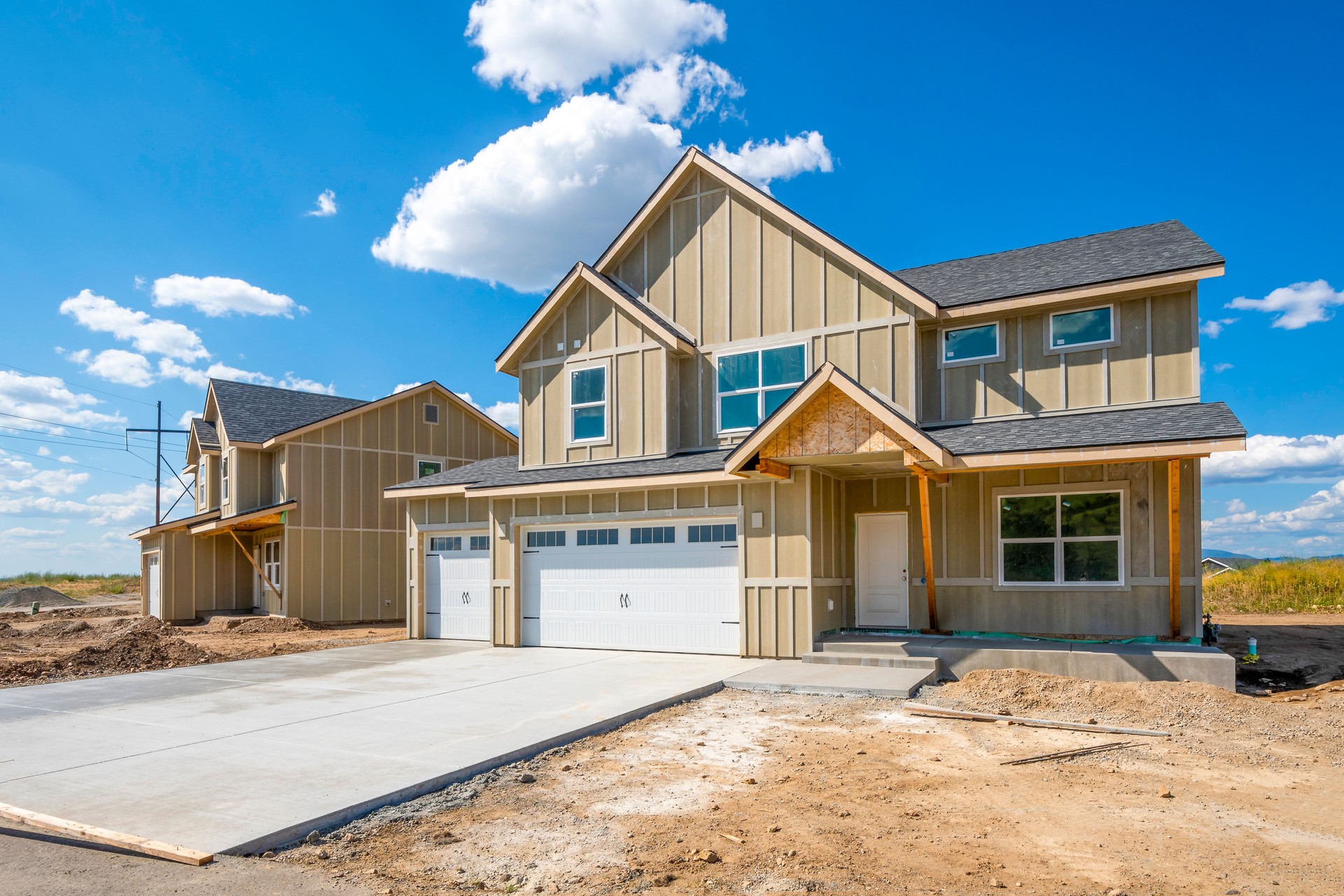 A street of partially finished new homes in a new suburban housing development in Spokane, Washington, USA.